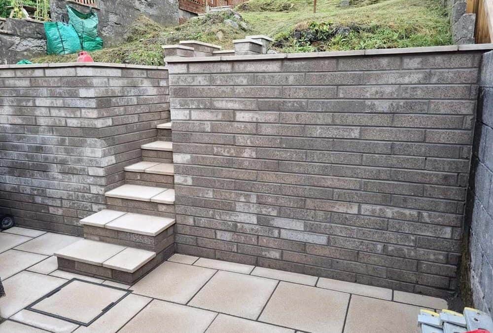 Patio area to front and rear with New retaining Wall installed